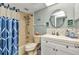 Cozy bathroom featuring a shower-tub combo, white vanity, and nautical decor for a charming ambiance at 26461 Explorer Rd # F, Punta Gorda, FL 33983
