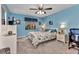 Cozy bedroom featuring a ceiling fan, carpet floors and nautical themed decor at 26461 Explorer Rd # F, Punta Gorda, FL 33983