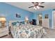 Bedroom with carpet, ceiling fan, a dresser, and a view into a home office space at 26461 Explorer Rd # F, Punta Gorda, FL 33983