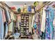 Spacious walk-in closet featuring clothing racks, shoe storage and overhead storage bins at 26461 Explorer Rd # F, Punta Gorda, FL 33983