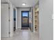 Bright condo entryway with tiled floor, storage shelves, natural light, and convenient access to other rooms at 26461 Explorer Rd # F, Punta Gorda, FL 33983