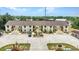 Spacious condo featuring a private entry, exterior stairs, landscaped grounds, and ample parking at 26461 Explorer Rd # F, Punta Gorda, FL 33983
