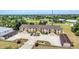 Aerial view of the condo building showcasing its landscaping, parking, and proximity to nearby golf course at 26461 Explorer Rd # F, Punta Gorda, FL 33983