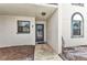 Condo featuring a welcoming entryway, with a view of the exterior landscape, and wall mounted light fixture at 26461 Explorer Rd # F, Punta Gorda, FL 33983