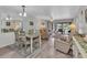 Inviting living room and dining area with sliding glass doors leading to a screened patio at 26461 Explorer Rd # F, Punta Gorda, FL 33983