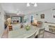 Open living and dining room layout with access to the screened lanai and a cozy atmosphere at 26461 Explorer Rd # F, Punta Gorda, FL 33983