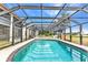 The screened in pool has blue tile and a metal frame at 26461 Explorer Rd # F, Punta Gorda, FL 33983