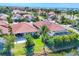 Aerial view showcases the tile roofs, landscaping, and private pond access at 303 11Th E Ave, Palmetto, FL 34221