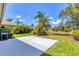 Backyard featuring a lawn, patio, grill, landscaping, and serene pond view at 303 11Th E Ave, Palmetto, FL 34221