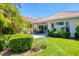 Relaxing backyard featuring a covered patio, lush green lawn, and tropical landscaping at 303 11Th E Ave, Palmetto, FL 34221