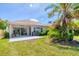 Backyard view with a patio, tropical landscaping, and outdoor grill at 303 11Th E Ave, Palmetto, FL 34221