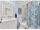 Bright bathroom features a lighted mirror, single vanity, and a shower-tub combo at 303 11Th E Ave, Palmetto, FL 34221