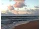 A stunning beach scene with waves gently rolling in and a pier stretching into the horizon at 303 11Th E Ave, Palmetto, FL 34221