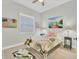 Cozy bedroom with tropical-themed decor, plush bedding, and a bright window with shade at 303 11Th E Ave, Palmetto, FL 34221