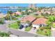 Beautiful single-Gathering home features a red tile roof, lush landscaping, and a paver driveway in a waterfront community at 303 11Th E Ave, Palmetto, FL 34221