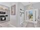 Bright foyer with decorative mirror and lighting fixtures leads into the kitchen with modern appliances and marble floors at 303 11Th E Ave, Palmetto, FL 34221