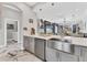 Open concept kitchen features a stainless steel sink and gray cabinets at 303 11Th E Ave, Palmetto, FL 34221