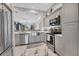 Kitchen with stainless appliances and gray cabinets overlooking living area at 303 11Th E Ave, Palmetto, FL 34221