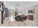 Spacious living room features stylish decor, a ceiling fan, and sliding glass doors to the outdoor patio and backyard at 303 11Th E Ave, Palmetto, FL 34221