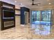 Beautiful living room featuring a modern fireplace, tile floors, and sliding glass doors to the exterior at 303 11Th E Ave, Palmetto, FL 34221