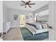 Main bedroom with ensuite bathroom, ceiling fan, and neutral tones at 303 11Th E Ave, Palmetto, FL 34221