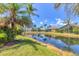 Picturesque pond view, showcasing tropical landscaping and waterfront homes at 303 11Th E Ave, Palmetto, FL 34221