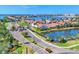 Street view showing community entry, pond, lush landscaping, and waterfront access at 303 11Th E Ave, Palmetto, FL 34221