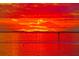 Vivid sunset over the water, casting a fiery glow across the sky and reflecting on the calm surface at 303 11Th E Ave, Palmetto, FL 34221