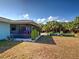 Exterior shot of a screened in patio, landscaping, and a garden at 4097 Rose Arbor Cir, Port Charlotte, FL 33948