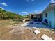 This sunny backyard patio area is framed by a raised garden bed at 4097 Rose Arbor Cir, Port Charlotte, FL 33948