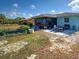 A backyard patio with a seating area, screened-in lanai, and garden beds is ideal for outdoor relaxation at 4097 Rose Arbor Cir, Port Charlotte, FL 33948