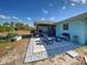 View of the outdoor patio area with adjacent lanai and raised garden at 4097 Rose Arbor Cir, Port Charlotte, FL 33948