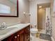 Bathroom featuring a cherry vanity, speckled countertops, and tiled walk-in shower at 4097 Rose Arbor Cir, Port Charlotte, FL 33948