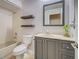 Bathroom features a tub and shower, floating shelves, gray vanity with granite top, and a view in the mirror at 4097 Rose Arbor Cir, Port Charlotte, FL 33948