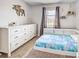 Comfortable bedroom featuring a dresser, a bed, a decorative moose, and a hanging shelf at 4097 Rose Arbor Cir, Port Charlotte, FL 33948
