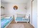 Charming bedroom with a crib and bed, adorned with colorful stars and mountain wall art at 4097 Rose Arbor Cir, Port Charlotte, FL 33948