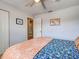 Cozy bedroom featuring a comfortable bed, ceiling fan, and access to an en-suite bathroom at 4097 Rose Arbor Cir, Port Charlotte, FL 33948