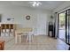 Bright dining area with tile flooring, a modern table, and sliding glass doors to outdoor area at 4097 Rose Arbor Cir, Port Charlotte, FL 33948