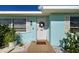 Cozy home with blue exterior, white trim, well-kept landscaping and pathway to the front door at 4097 Rose Arbor Cir, Port Charlotte, FL 33948