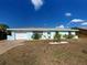 Well-kept single-story home with a blue exterior, white trim, and a manicured front yard at 4097 Rose Arbor Cir, Port Charlotte, FL 33948