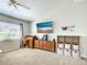 Carpeted living room featuring a ceiling fan and built-in storage at 4097 Rose Arbor Cir, Port Charlotte, FL 33948