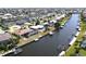 Scenic aerial view of a home with screened pool, dock, and canal access at 425 Belvedere Ct, Punta Gorda, FL 33950