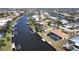 Aerial view of a home with a screened pool, personal dock, and access to a canal at 425 Belvedere Ct, Punta Gorda, FL 33950