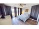 Well-lit bedroom with wood-look floors, ceiling fan, and serene view at 425 Belvedere Ct, Punta Gorda, FL 33950
