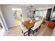 Open dining area view into the kitchen, lanai, and living room; features wood floors and natural lighting at 425 Belvedere Ct, Punta Gorda, FL 33950
