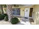 Charming home front entrance adorned with lush greenery and a contemporary door at 425 Belvedere Ct, Punta Gorda, FL 33950