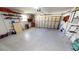Spacious garage featuring a garage door, ample storage shelves, and epoxy flooring at 425 Belvedere Ct, Punta Gorda, FL 33950