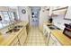 Traditional kitchen featuring white cabinets and tiled floors, with a view to the backyard at 425 Belvedere Ct, Punta Gorda, FL 33950