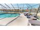 Sparkling pool in a screened enclosure with lounge chairs, perfect for relaxation at 425 Belvedere Ct, Punta Gorda, FL 33950