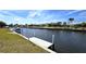 Waterfront community featuring boat dock, serene canal, and beautiful landscaping at 425 Belvedere Ct, Punta Gorda, FL 33950